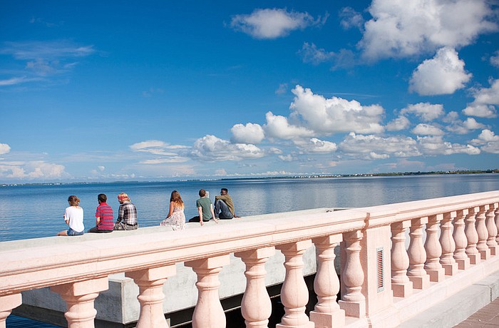 New College students Maria Phillips, Alan Sachnowski, Kade Needham, Krystaal McClain, Christian Metzger and Sivens Glaude sit on the bayfront dock in July. Courtesy photo.