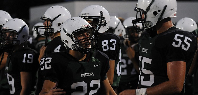 Lakewood Ranch senior cornerback Andre Christiano goes over the game plan with senior linebacker Luke Sears.