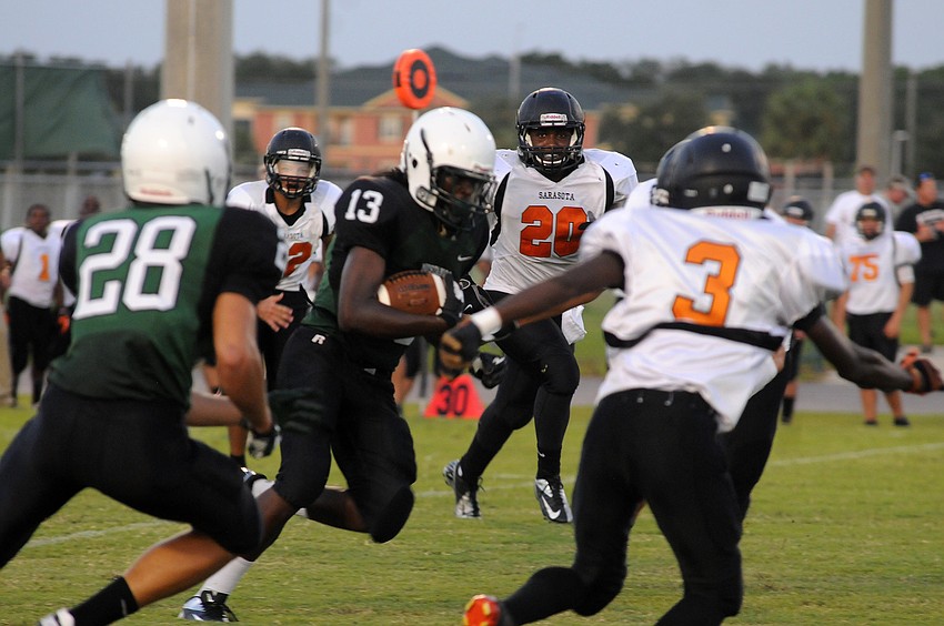 Lakewood Ranch sophomore Terez Davis looks for an open lane during the Mustangs preseason kickoff classic versus Sarasota Friday night.