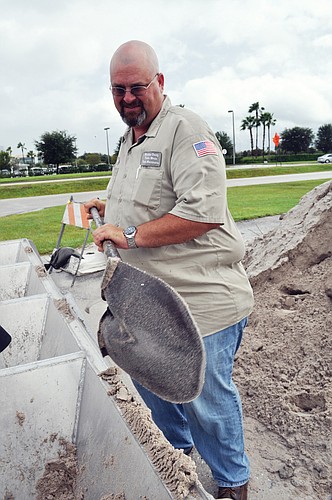 Manatee County's Todd Bonds helps East County residents fill bags of sand for the storm.