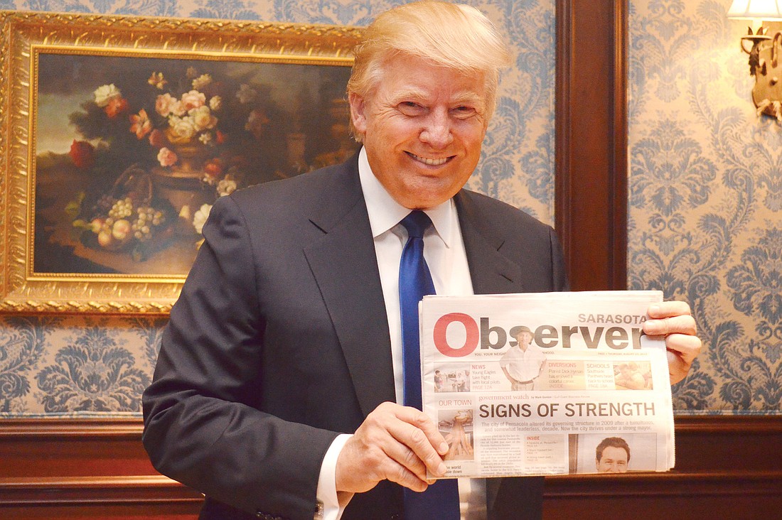 Donald Trump, holding his copy of the Sarasota Observer, told reporters during a press conference Sunday, at the Ritz-Carlton, Sarasota, that if President Barack Obama is re-elected, there might not be a country left in four years. Photo by Loren Mayo.
