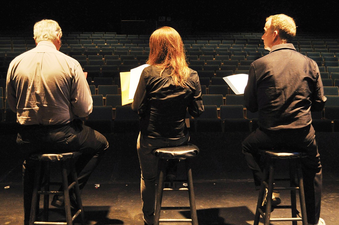 Three of the four cast members practice the reading of "nine/eleven": Michael Phelan, Brooke Wagstaff and Players Theatre Artistic Director Jeffery Kin. "This is going to be a tough one," Kin says. Linda MacCluggage not pictured.