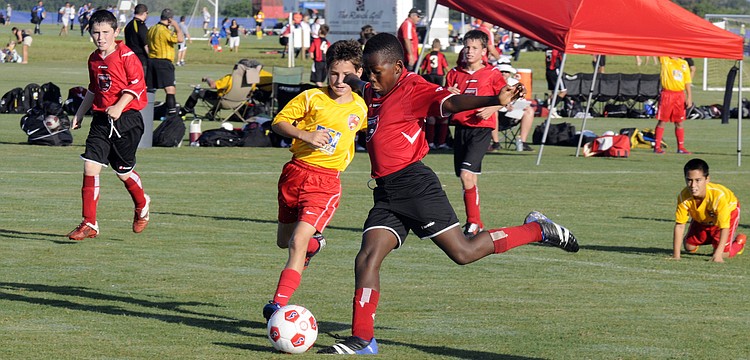 Center midfielder Malcolm Lewis attempts a shot for the Wesley Chapel Flames.
