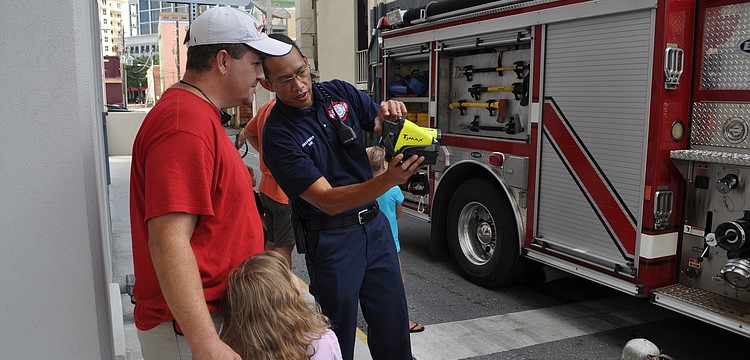 Miguel Fenix shows Alex and Spencer Schurawel how to use a thermal camera.