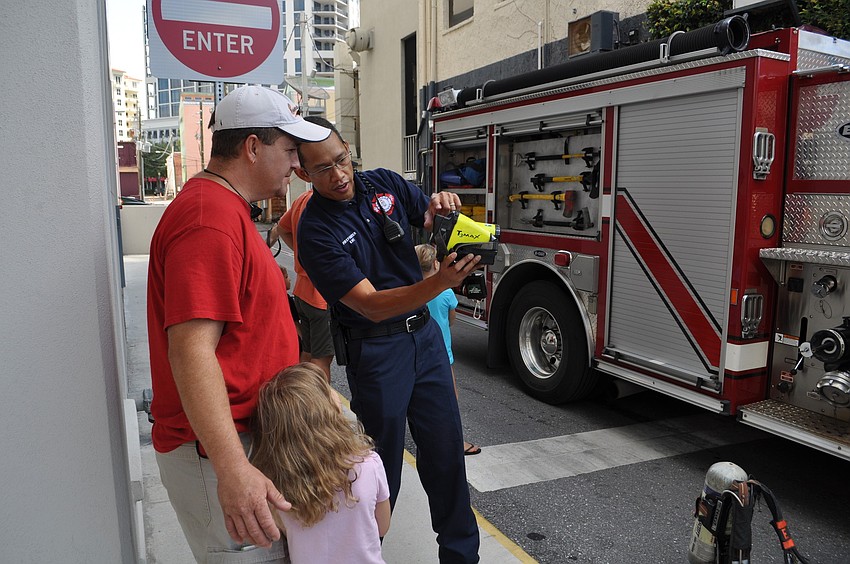 Miguel Fenix shows Alex and Spencer Schurawel how to use a thermal camera.