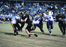 Sarasota High School cornerback Quincy Battie, right, rushes after a turnover from Booker High School's offense in the first regular season game Friday, Aug. 31. The Sailors bested the Tornadoes 51-6.