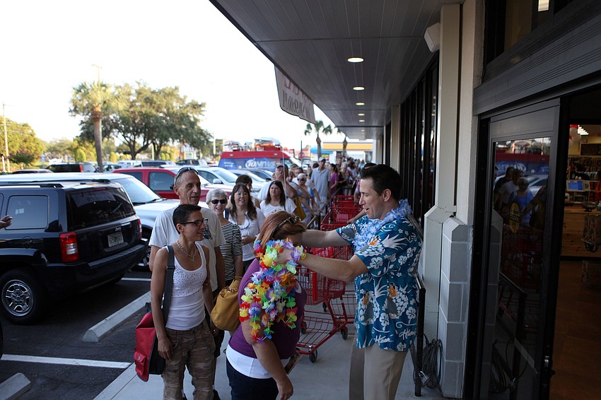 As customers made their way into the store they were given a lei and a shopping cart.
