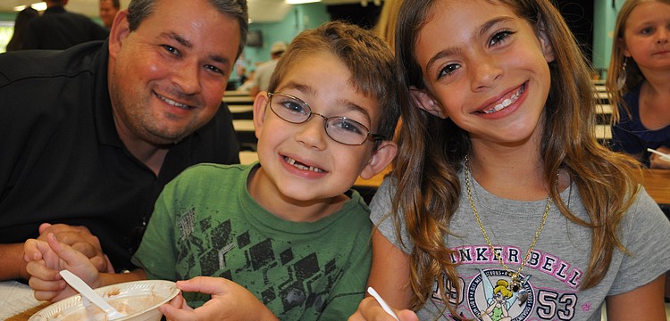 Dillon Forbes, center, enjoyed ice cream with his dad, Lee, and friend Gianna Caso, right.