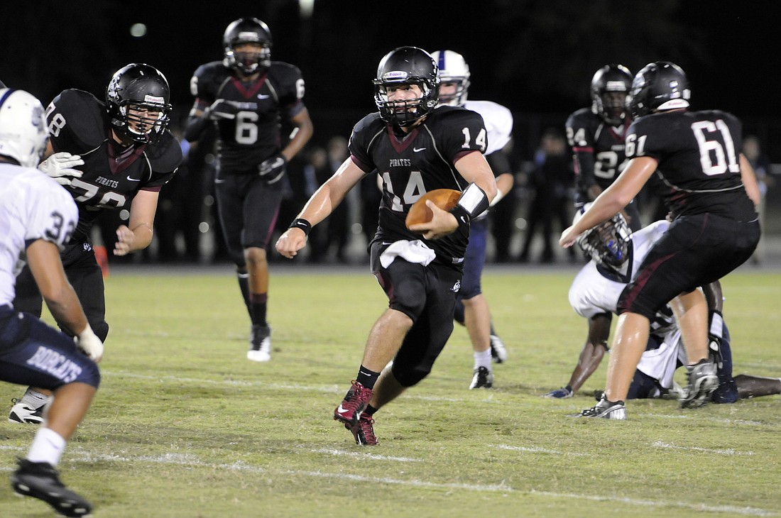 Braden River quarterback Eric Schappacher scrambles for a first down during the second quarter of the Pirates 42-0 loss to North Port.