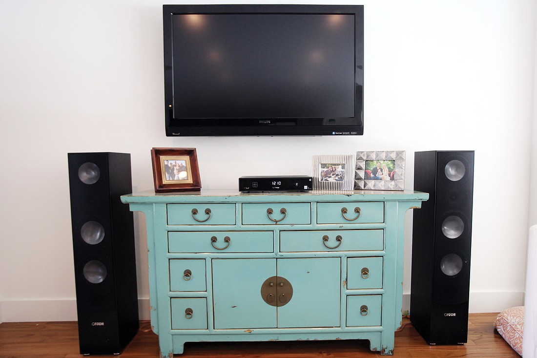 Sara Ferguson bought this TV console at the Sarasota Pamaro Shop years ago and knew she wanted the piece to be one of the big pops of color in their home.
