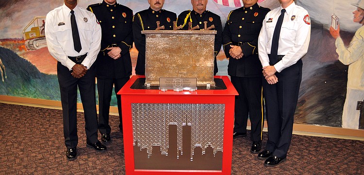 Members of the Sarasota Honor Guard pose with the World Trade Center artifact.