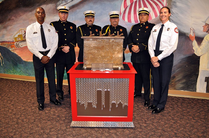 Members of the Sarasota Honor Guard pose with the World Trade Center artifact.