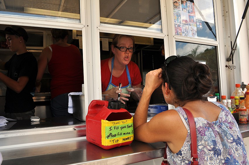 Michelle Jett takes an order from Tonya Saah from the Baja Boys Grill truck Tuesday, Sept. 11, opening day for Ringling Picnic.