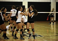 Jordan Brooks, No. 12, high fives her teammate CeCe Knight, No. 3, after making an impressive play Tuesday, Sept. 11 during the Cardinal Mooney versus Sarasota High School JV volleyball game at Sarasota High School.