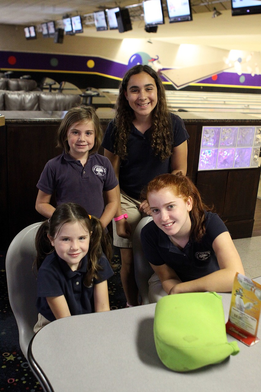 Caitlin Pacer, 7, with her buddy Simone Timol, 12, and seated, Lora Rini, 7, with her buddy Zoe Fenn, 12