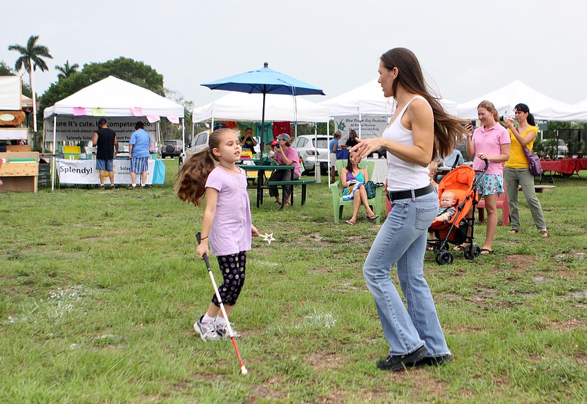 Kyah Palmisano, 8, and her mom, Candi, have fun dancing to the Garbage Men, Wednesday, June 6, during Childrenâ€™s Day.