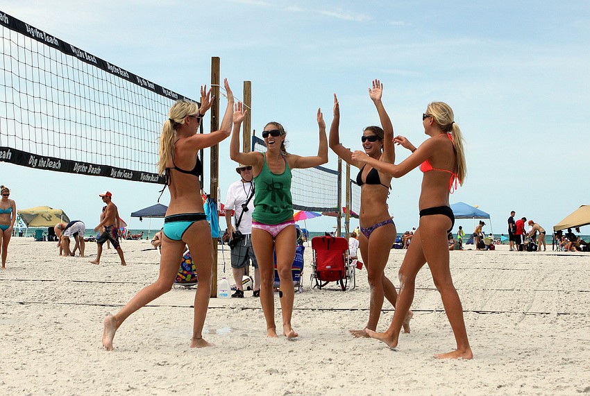 Melissa Moore, Melissa Pelligringa, Stephanie Pelligringa and Nina Pellitteri high five one another after making an impressive play.