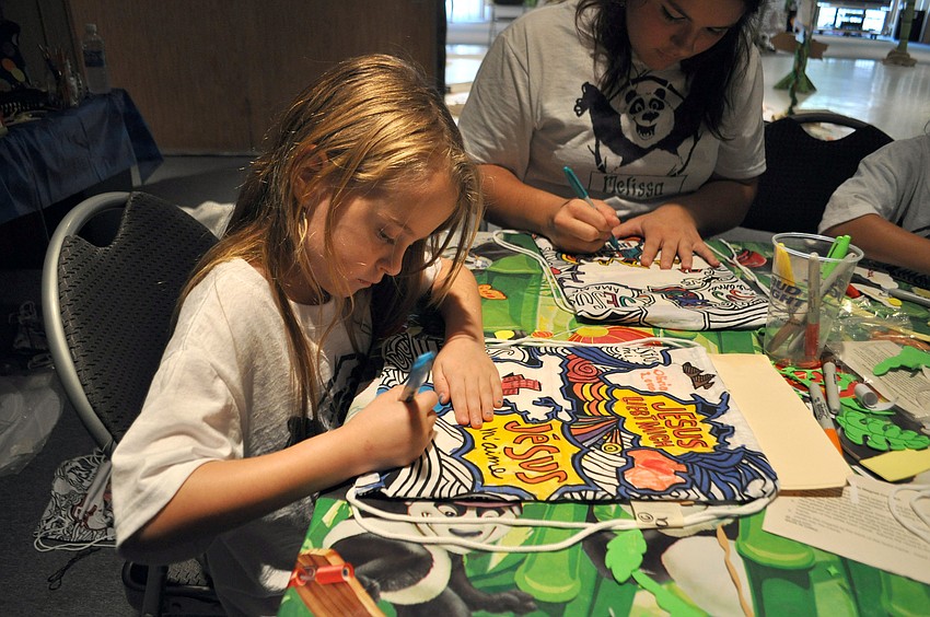 Olivia Love works on her backpack.