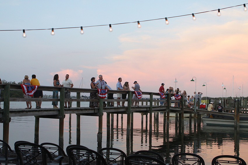 Those dining at Mar Vista wander the dock at the restaurant after eating dinner and before the firework display began, Monday, July 2, on Longboat Key.