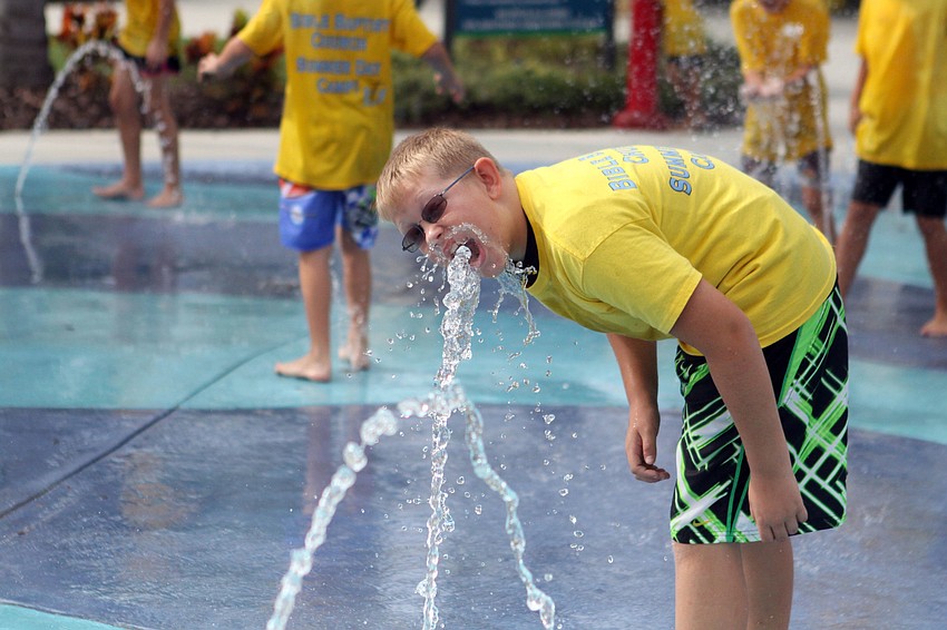 Thomas Joy, 10, has fun playing at Splash Park at Central Park playground, Wednesday, July 18.