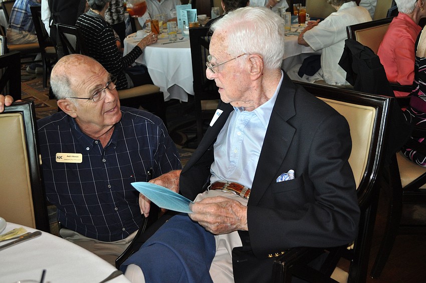 Andy Maass bends down to talk with Bob Rosenthal.