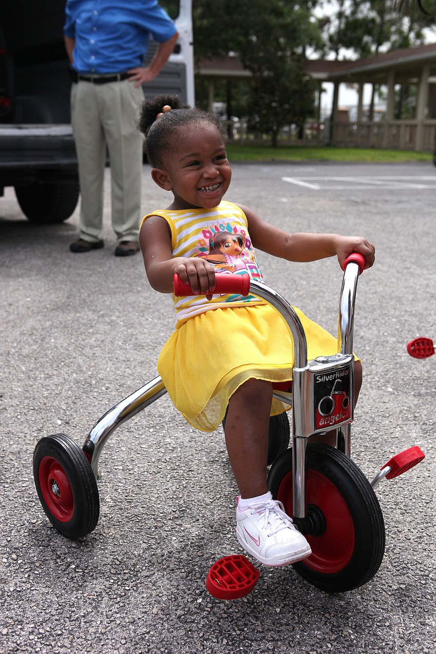 Ashyiah Davis, 2, was very excited about the new tricycles.