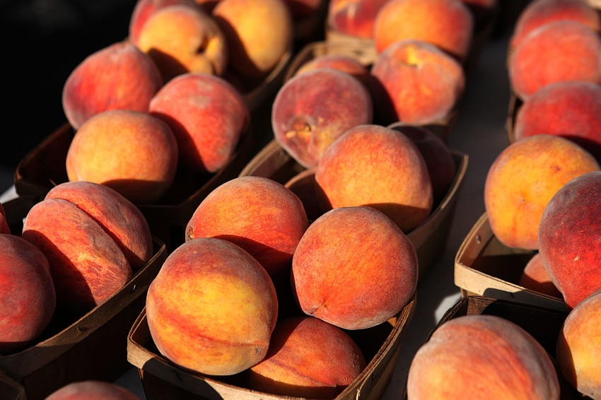 Ripe peaches at Yum Yum Treeâ€™s tent at the Siesta Key Farmers Market.