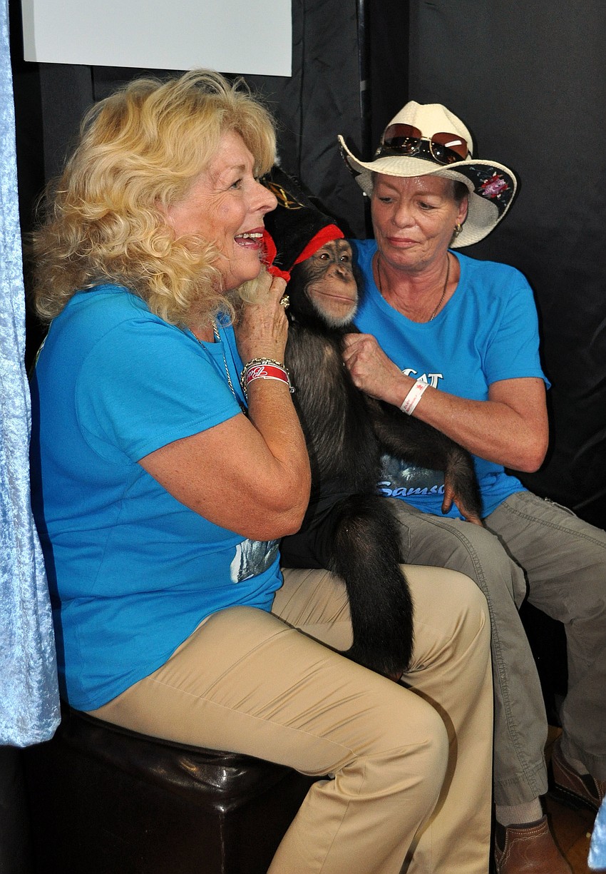 Kay Rosaire and Pam Rosaire Zoppe pose with Chance inside Complete's Party Box Photo Booth.