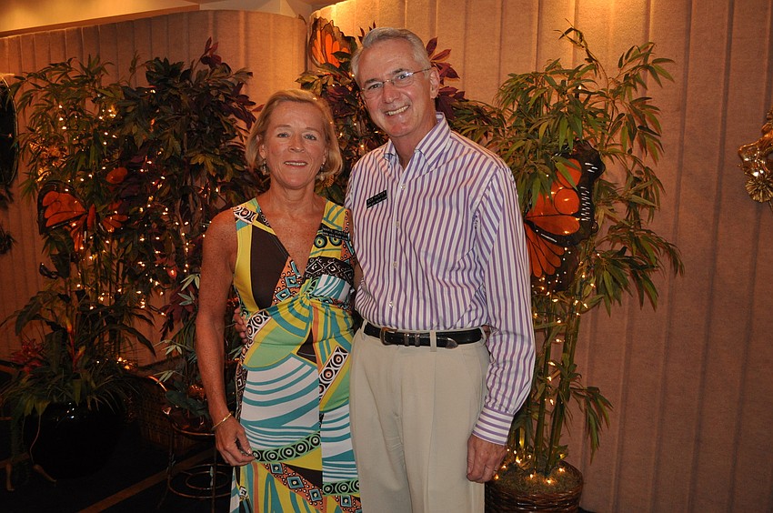 Marie and Commodore Bob Hunter pose by the â€œrain forestâ€ Saturday, Sept. 8 at Bird Key Yacht Clubâ€™s Carnival.