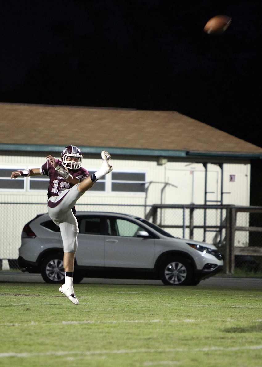 Dominic Marino, No. 12, punts the ball down the field.