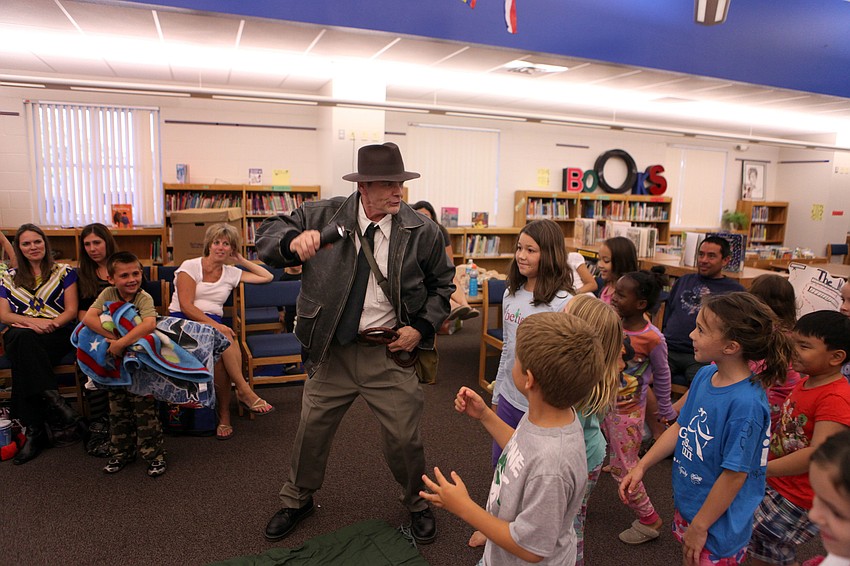 Michael Gange leads the students on a hunt for treasure, Thursday, April 26, during Phillippi Shoresâ€™ storybook and PJ night.