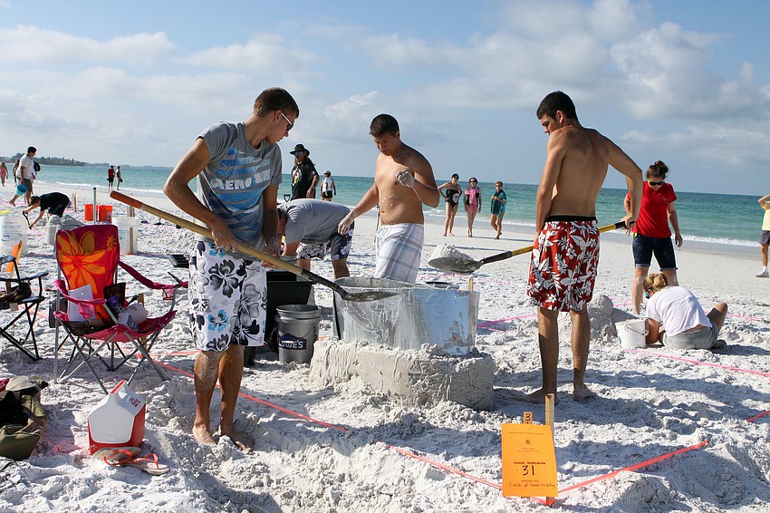 Justin Muklewicz, Lukas LaBanauskas and Greg Ratzael work on their piece, Saturday, May 5.