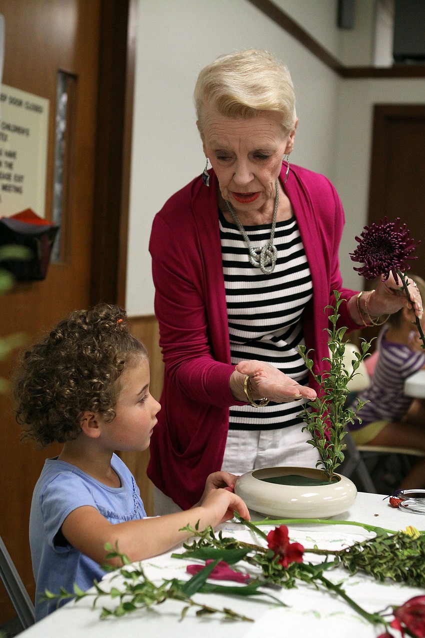 Sensei Adrienne Wagner helps Lilly Mae Stewart, 6, with creating an Ikebana arrangement for Motherâ€™s Day.
