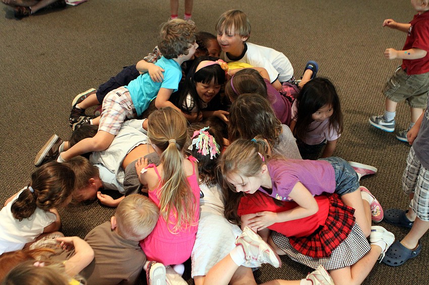 The students pile on top of one another during â€œThe Leavesâ€ song.