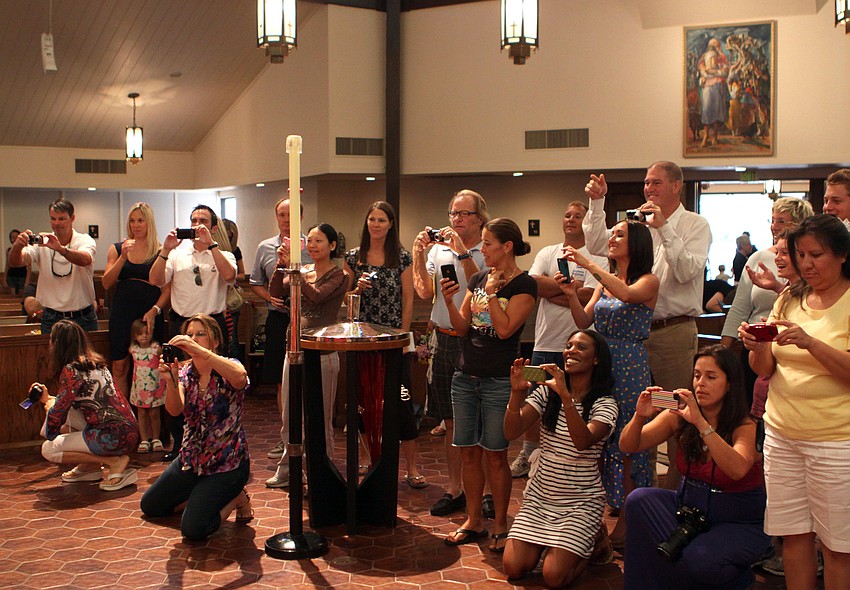 Parents of the Seahorse class take photos of the graduates in their caps and gowns.