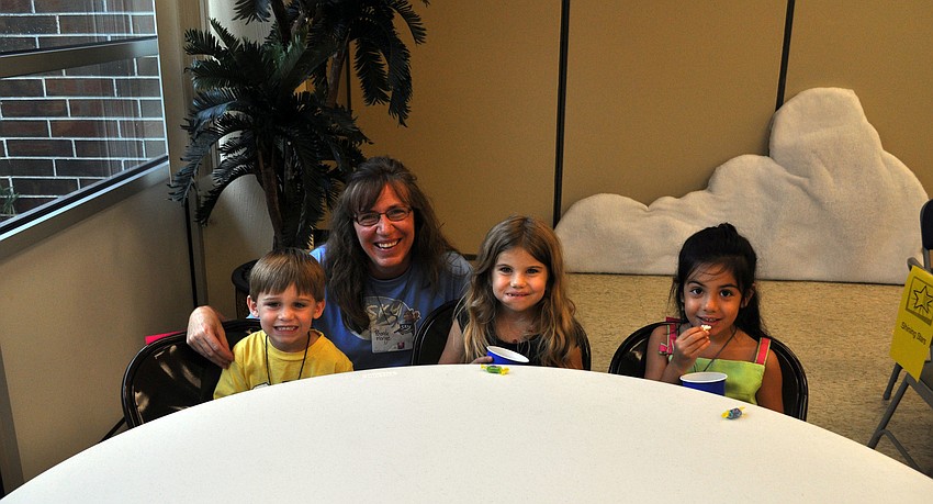 Rhonda Monge poses with students Nix, Lauren and Juliana