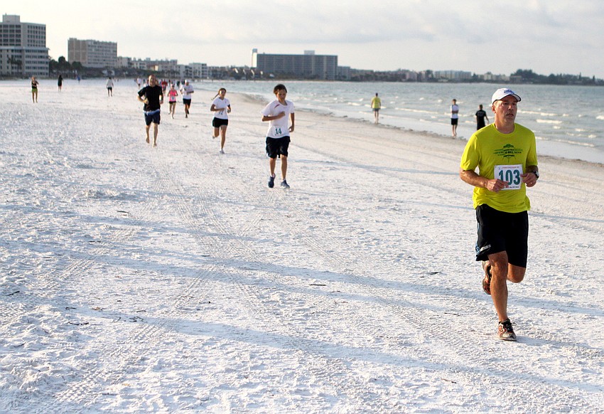 Participants in the Firecracker 5K make their way towards the finish line, Saturday, June 30, on Siesta Key Public Beach.