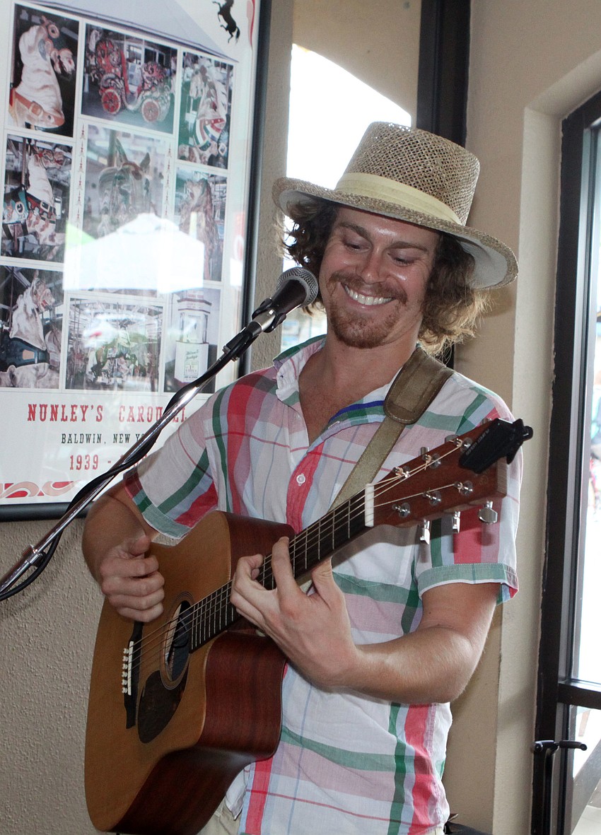 Patrick Stoutenborough played his guitar during the Drink Pink event, Saturday, July 14, at the Village CafÃ©.