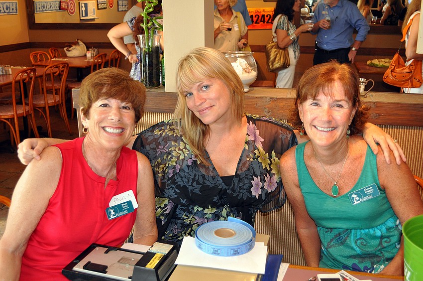 Paula Stein, Chastanna Neimann and Rhonda Wiggins pose together, Thursday, Aug. 16, during the SKCC After Hours at the Village CafÃ©.