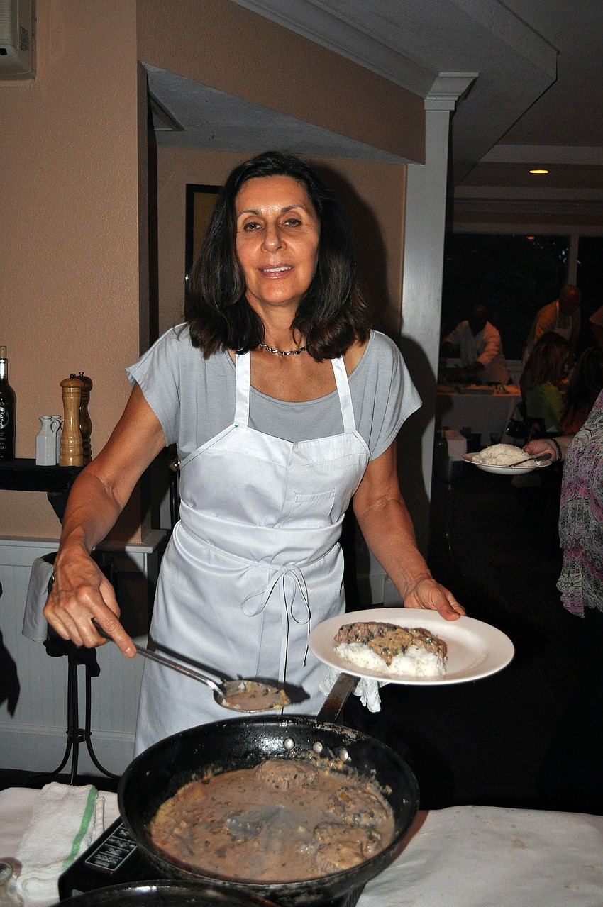 Phyllis Refi smiles as she serves up her dish, Friday, Aug. 17, at Pattigeorgeâ€™s.