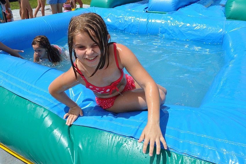 Lacey Currier, 7, slid as fast as she could.