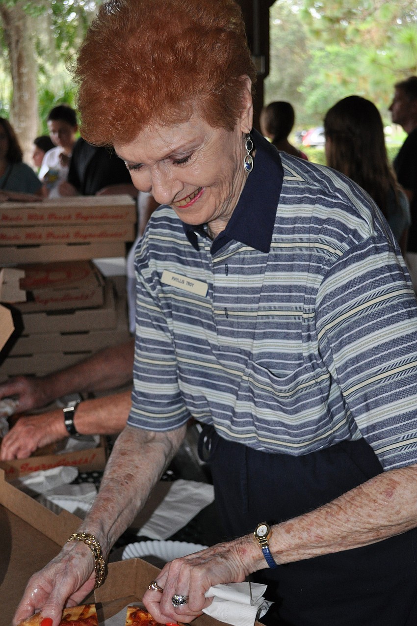 Summerfield resident Phyllis Troy serves pizza.