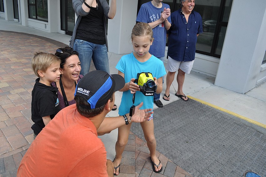 Robert Zamsky shows his daughter, Florence, how to use the firefightersâ€™ thermal camera.