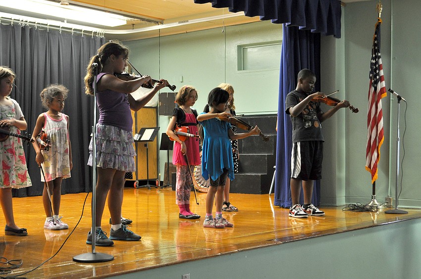 Students perform on violin.
