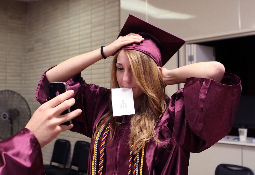 Anna Zeljazkow had Christian Jarvis hold up her iPhone so she could properly put her cap on, Saturday, June 2.