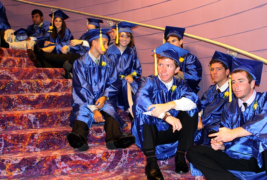 Some of the students sat down on the stairs while they waited to graduate, Sunday, June 3, at Van Wezel.