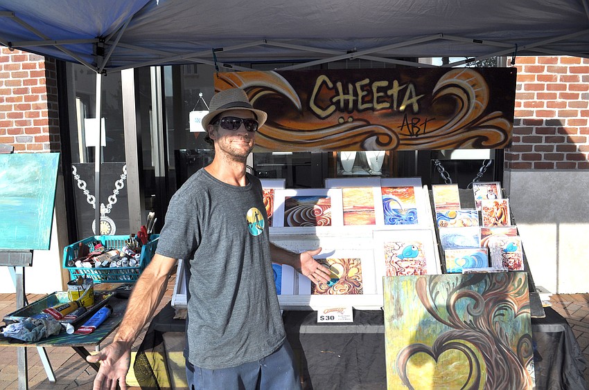 Chad Ruis shows off his artwork.