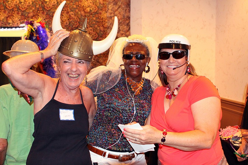Irene Herman, Patricia Curry and Tomi Arnold try on a variety of different hats before heading into the photo booth.