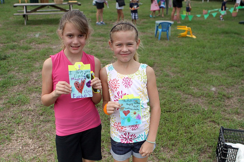 Ashlee Kate Lenz, 8, and Isabella Dos Santos, 7, show off the cards they made for Fatherâ€™s Day.