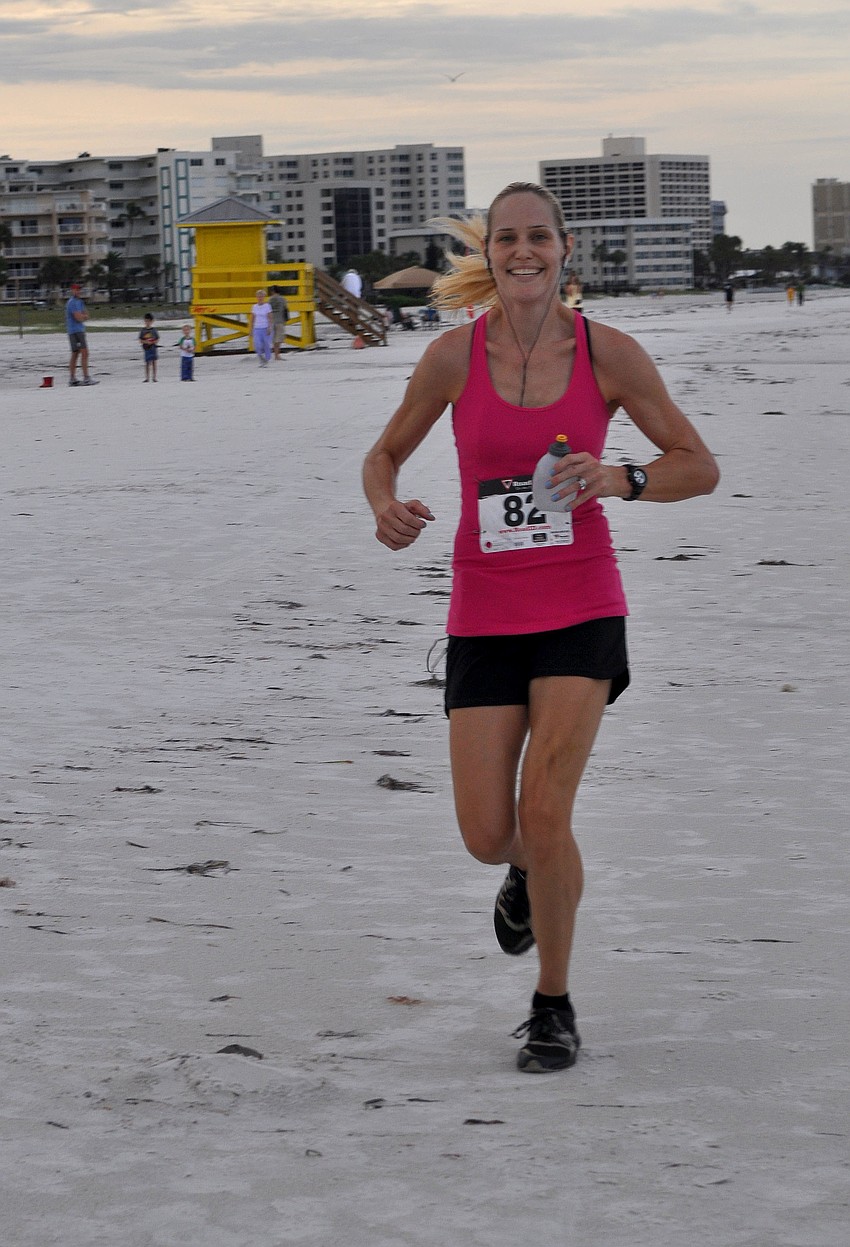 Colleen Orbegoso with the first woman and the fifth person to cross the finish line with a time of 20:18.